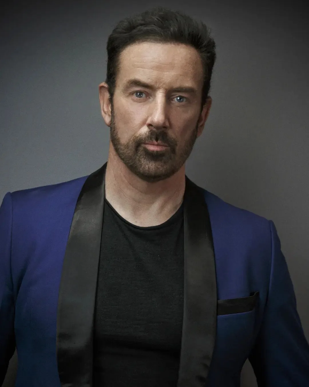 Portrait photograph of Bryan Larkin from 1973 style profile